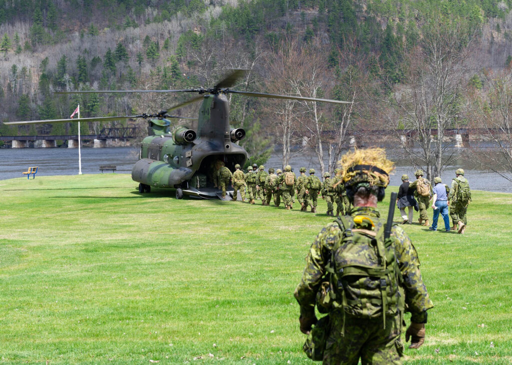 Canadian Armed Forces loading into helicopter.
